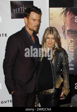 Showing off her baby bump as she awaits the arrival of her first child any day now, Fergie was spotted arriving at the premiere of her husband Josh Duhamel's latest film, 'Scenic Route' held at the Chinese 6 Theatre in Hollywood. The 38 year old 'Black Eyed Peas' singer looked amazing in a black studded leather jacket with a sheer black top and black leather pants. Fergie and Josh are reportedly awaiting the arrival of their son at any moment but that did not stop Fergie from coming out to support her hunky husband at his movie premiere. Looking all-aglow, the happy couple appeared in great sp Stock Photo