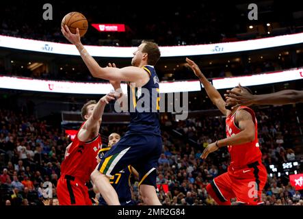 Orlando Magic's D.J. Augustin (14) looks for an opening past Utah Jazz's  Joe Ingles, middle, as Magic's Bismack Biyombo stands near Ingles during  the first half of an NBA basketball game Saturday