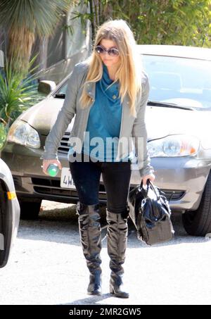 Singer Fergie and an assistant leave Fergie's Los Angeles home. Perhaps the pair are headed out to make some final arrangements for Fergie's wedding to actor Josh Duhamel, reportedly scheduled for January 10. Fergie and Josh met in 2004 when she and her group The Black Eyed Peas made an appearance on his show 'Las Vegas' and have been engaged since early last year. Los Angeles, CA. 1/6/09. Stock Photo