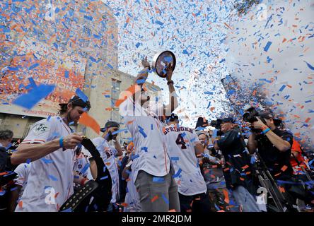 Houston Astros shortstop Carlos Correa hoists the World Series championship  trophy as he walks on the st…