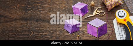 Diamonds stitched in the form of a cube. The process of sewing a quilt. Stock Photo