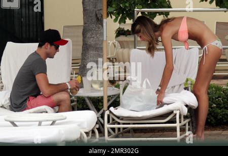 EXCLUSIVE!! Kings of Leon bass player, Jared Followill, and his new model fiancŽ Martha Patterson, get in some poolside relaxation time. Jared, who is currently on a tour break, sipped cocktails with Martha who showed off her slim figure in a bikini. The couple announced their engagement last month and Martha was proudly wearing her ring. South Florida. 6th June 2012. Stock Photo