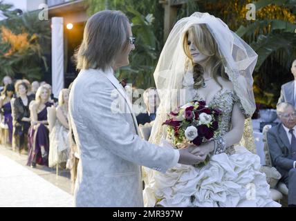 EXCLUSIVE!! Internationally renowned architect Brad Friedmutter and celebrity hypnotist Kimberly Stevens were recently joined in union at their lavish Las Vegas wedding atop a bluff at the couple's Shangri-Las Vegas mansion. Prior to, during and after the October 23rd ceremony, guests were treated to festivities that included tunes spun by Las Vegas DJ Rodney Munnings and songs sung by Ricki Beyers Beckwith, along with hors dÕoeuvres, specialty cocktails and cigars. During the ceremony, spectacular visuals introduced the beautiful bride who wore a gorgeous handmade corset gown by Beverly Hills Stock Photo