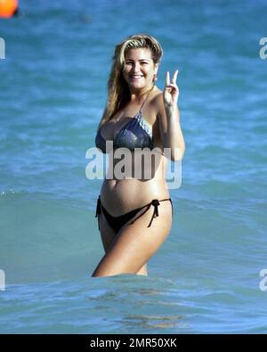 EXCLUSIVE!! Playboy Model, Josie Goldberg, dons a sparkling silver bikini during a day on the beach. Josie, who is currently in town to see a specialist doctor about her keloid scar, also took a dip in the ocean after which her bandaid dislodged to reveal the scar. Miami Beach, FL. 1/2/11.     . Stock Photo