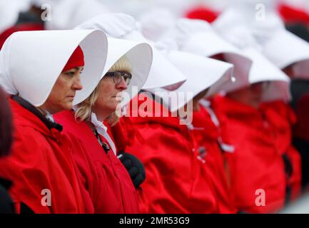 red dresses white bonnets Here's Why Women Keep Dressing Like 'Handmaids' at Statehouses