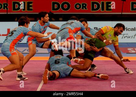 Players of Puneri Paltan pin down Monu Goyat, in green jersey, of Patna  Pirates during their Vivo Pro Kabaddi league match in Mumbai, India,  Tuesday, Oct. 24, 2017. (AP Photo/Rafiq Maqbool Stock