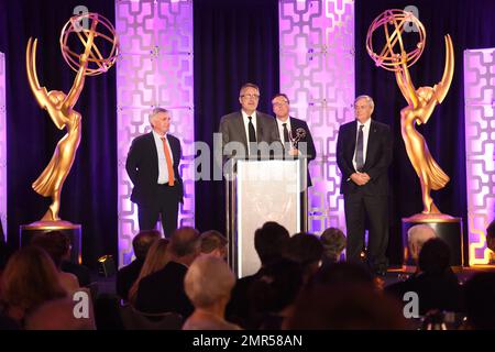 Rick Dempsey, from left, Jeff Miller, Brian Sanders, and Andy Aherne pose  with the Engineering Emmy Award for Disney Global Localization at the 69th  Engineering Emmy Awards, presented by the Television Academy