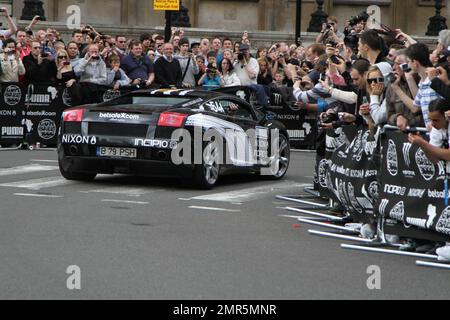 Cars race at the 11th annual Gumball 3000 rally race, which kicks off in London and will see participants race through the streets of Amsterdam, Copenhagen, Stockholm, Boston, Quebec City, Toronto and New York City.  The good spirited race prides itself on not keeping timing scores and acts more as a showcase for high-end sports cars an novelty automobiles. London, UK. 05/01/10. Stock Photo