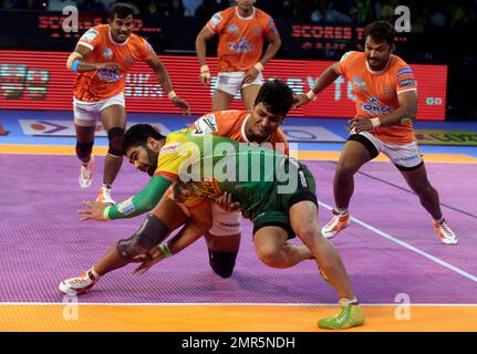 Players of Puneri Paltan pin down Monu Goyat, in green jersey, of Patna  Pirates during their Vivo Pro Kabaddi league match in Mumbai, India,  Tuesday, Oct. 24, 2017. (AP Photo/Rafiq Maqbool Stock