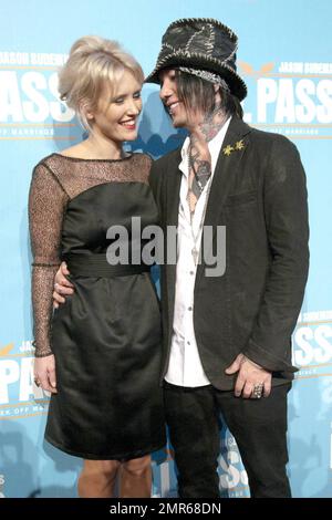 Australian actress and model Nicky Whelan, who appears in 'Hall Pass', and boyfriend DJ Ashba, current guitarist for the rock bands Sixx:A.M. and Guns N' Roses, poses for photographers on the red carpet at the Australian premiere of the new Farrelly brother's comedy 'Hall Pass' held at The Entertainment Quarter. Sydney, AUS. 02/27/11. Stock Photo