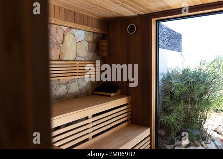 General view of sauna with wooden benches and window Stock Photo
