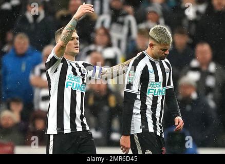 Newcastle United's Bruno Guimaraes and Kieran Trippier lift the trophy ...