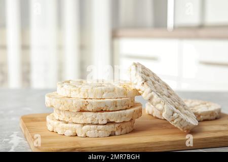 Stack of crunchy rice cakes on grey marble table indoors Stock Photo