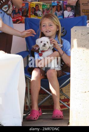 'Project Runway' host & supermodel Heidi Klum and daughter Leni Samuel help support Leni's Girl Scout troup by helping with the cookie sale in Brentwood. 7 year old Leni, who looked adorable in her Girl Scout uniform, was seen selling cookies to an elderly man while mommy Heidi stood beside her for support. Leni was also seen holding a white puppy while putting in her time at the cookie sale. Both mother and daughter were later seen leaving hand in hand. Los Angeles, CA. 10th March 2012. Stock Photo