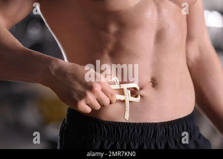 https://l450v.alamy.com/450v/2mr7kn0/man-measuring-body-fat-layer-with-caliper-indoors-closeup-2mr7kn0.jpg