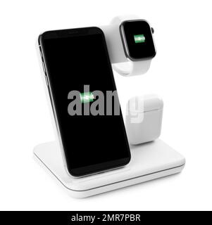Set of gadgets charging with wireless pad isolated on white Stock Photo