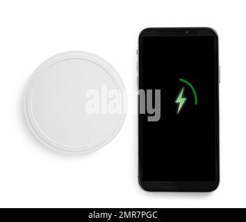 Wireless charger and smartphone isolated on white, top view Stock Photo