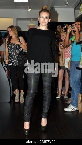 Wearing a black top and camouflage patterned leather pants, actress Hilary Duff delights a huge crowd of fans by signing copies of her new book 'Elixir' at Books & Books in the Bal Harbor Shops in Bal Harbor, FL. 10/15/10. Stock Photo