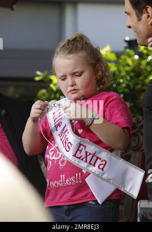 Honey Boo Boo (aka Alana Thompson), star of the TLC reality show 'Here Comes Honey Boo Boo,' and her mother June Shannon make an appearance at The Grove shopping center for an interview with Jerry Penacoli. During the interview, the child beauty pageant star wore a sash that read 'Little Miss Extra.' Los Angeles, CA. 15th October 2012. Stock Photo