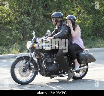 Exclusive!! Hugh Laurie takes his daughter Rebecca for a ride on his Triumph Bonneville motorcycle in Beverly HIlls, Calif. 8/22/07. Stock Photo