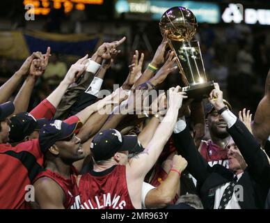 FILE - In this June 20, 2006, file photo, Miami Heat coach Pat Riley, right, helps lift the Larry O'Brien Trophy after beating the Dallas Mavericks in Game 6 of the NBA basketball finals in Dallas. The Miami Heat president has stockpiled nine championship rings, became a best-selling author and motivational speaker, transformed the fashion sense of NBA coaches and left an indelible mark on franchises in Los Angeles, New York and Miami.And he's not done. (AP Photo/Eric Gay, File)