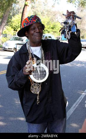 Fans and friends gather outside the Jackson family compound to leave flowers and gifts and pay their respects as the family arrives from UCLA Medical Center where Michael Jackson was pronounced dead after suffering from cardiac arrest this afternoon. Encino, CA. 6/25/09. Stock Photo