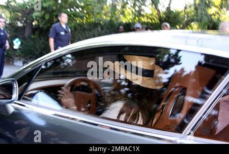 Fans and friends gather outside the Jackson family compound to leave flowers and gifts and pay their respects as the family arrives from UCLA Medical Center where Michael Jackson was pronounced dead after suffering from cardiac arrest this afternoon. Encino, CA. 6/25/09. . Stock Photo