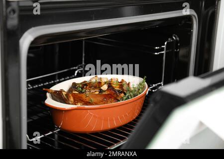 Delicious roasted ribs with thyme in oven Stock Photo