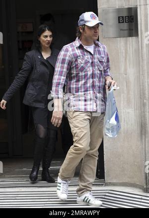 Celebrity chef Jamie Oliver chats on his cellphone while leaving the