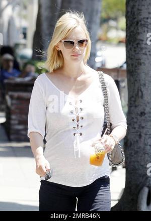 A pregnant January Jones and a friend grab lunch in Hollywood before shopping in the baby section of a nearby Target. The Mad Men actress was all smiles as she strolled in the sunshine. Los Angeles, CA 6/18/2011 Stock Photo