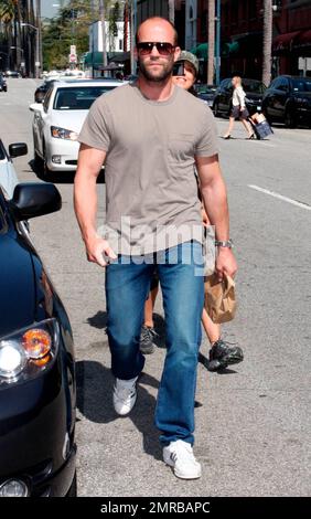 Action star Jason Statham, who is currently filming 'The Mechanic', looks a bit scruffy while carrying a brown paper bag after leaving a medical building on Bedford Drive. Los Angeles, CA. 03/18/10. Stock Photo