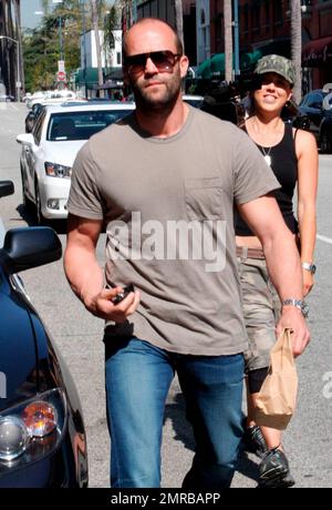 Action star Jason Statham, who is currently filming 'The Mechanic', looks a bit scruffy while carrying a brown paper bag after leaving a medical building on Bedford Drive. Los Angeles, CA. 03/18/10.   . Stock Photo