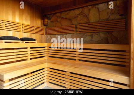 Wooden benches in sauna room at health spa, copy space Stock Photo