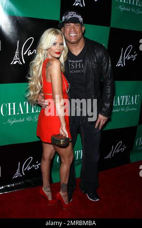 Former adult film star Jenna Jameson shows off her tattooed legs in a baby-doll red mini dress and cherry-red platform stilettos as she celebrates her 37th birthday at Chateau Nightclub with on-off boyfriend UFC fighter Tito Ortiz.  Jameson showed off her long blonde hair as she blew kisses and sucked on a Sugar Factory lollipop. Las Vegas, NV. 04/09/11. Stock Photo