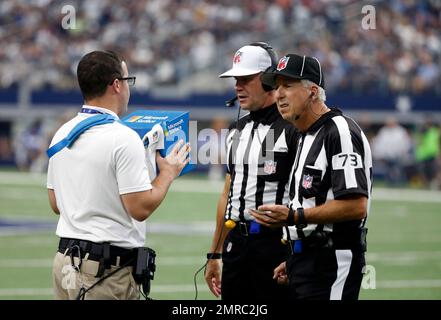 Referee Clete Blakeman (34) and side judge Joe Larrew (73) stand on the  sideline watching an instant replay during an NFL football game between the  Los Angeles Rams and Dallas Cowboys on