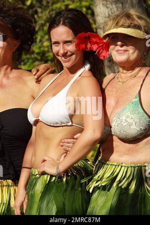 EXCLUSIVE!! With a tropical flower in her hair Jennifer Love Hewitt, 31, beamed in the Hawaiian sunlight as she and boyfriend of six months Alex Beh, 27, hugged and enjoyed the afternoon on New Year's Day in what appeared to be a gathering of friends and family, including her mom Pat who wore a black bathing suit, at their hotel. Showing off her natural curves Jennifer looked lovely in a white bikini and traditional hula skirt made of leaves. Maui, HI. 01/01/11.     . Stock Photo