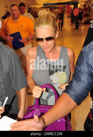Actress Jenny McCarthy signs autographs as she makes her way through