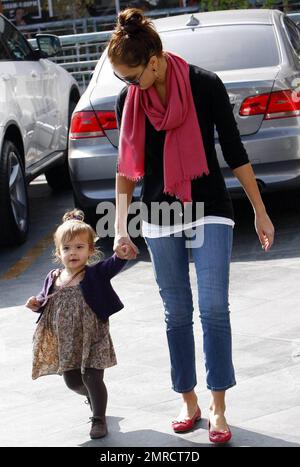 - Doting mom Jessica Alba looks on as her daughter Honor practices walking while leaving a restaurant in West Hollywood. Jessica keeps close to come to Honor's aid in case of an accidental fall and later holds her hand while they head to thier vehicle. Los Angeles, CA. 11/8/09. Stock Photo