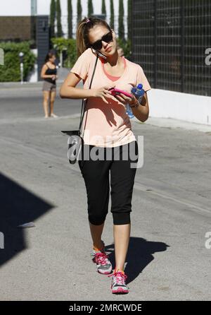 Jessica Alba was spotted heading to her pilates class in West Hollywood while wearing a pink top, black work out pants and pink sneakers while talking on her cell phone. Jessica made sure to keep herself hydrated during her work out by bringing a large bottle of water along. Los Angeles, CA. 2nd August 2012. Stock Photo
