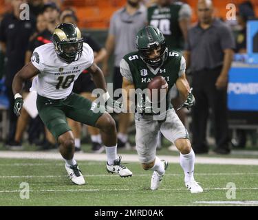 Hawaii wide receiver John Ursua (5), front, is dragged down by Colorado  State cornerback Anthony Hawkins after catching a pass for a touchdown in  the first half of an NCAA college football