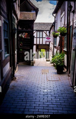 England vernacular architecture with an outdoor enclosed stairway, timber framing and a gateway to the garden in Winchcombe, a Cotswold   market town. Stock Photo
