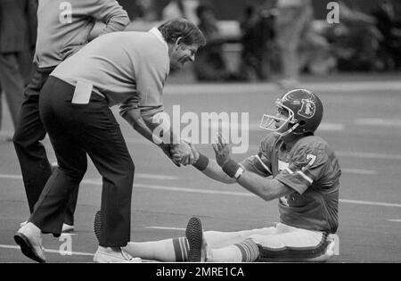 Head coach Red Miller of Denver Broncos, left, and Tom Landry, head coach  of the Dallas Cowboys shake hands on the playing field at the Superdome  prior to Super Bowl XII in