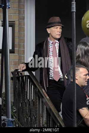 Actor John Malkovich smokes a cigarette while on the set of 'Red 2' in London, UK. 12th November 2012. Stock Photo