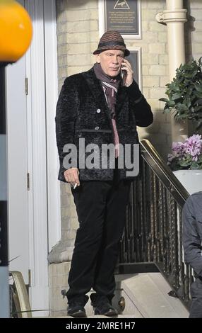 Actor John Malkovich smokes a cigarette while on the set of 'Red 2' in London, UK. 12th November 2012. Stock Photo