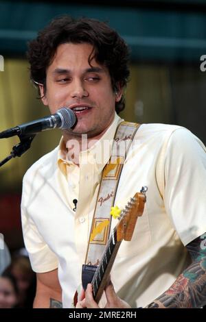 John Mayer looks dressed for summer in a pale yellow shirt and plaid pants as he performs on NBC's 'Today' Summer Concert Series live at Rockefeller Plaza in New York, NY. 7/23/10. Stock Photo