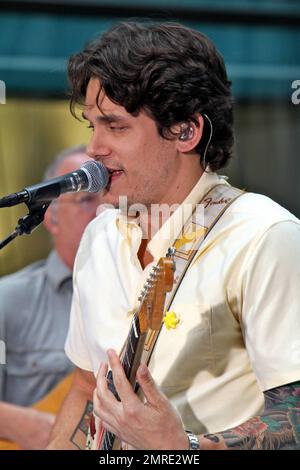 John Mayer looks dressed for summer in a pale yellow shirt and plaid pants as he performs on NBC's 'Today' Summer Concert Series live at Rockefeller Plaza in New York, NY. 7/23/10. Stock Photo