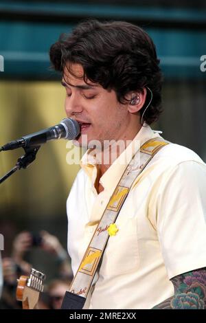 John Mayer looks dressed for summer in a pale yellow shirt and plaid pants as he performs on NBC's 'Today' Summer Concert Series live at Rockefeller Plaza in New York, NY. 7/23/10. Stock Photo