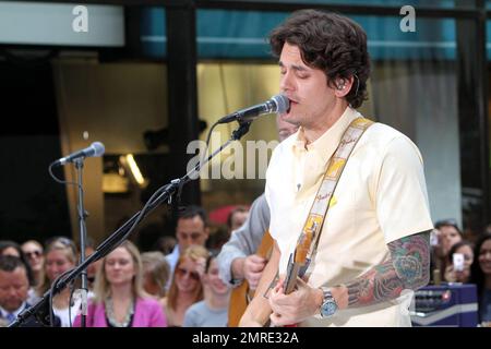 John Mayer looks dressed for summer in a pale yellow shirt and plaid pants as he performs on NBC's 'Today' Summer Concert Series live at Rockefeller Plaza in New York, NY. 7/23/10.   . Stock Photo