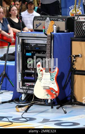 John Mayer looks dressed for summer in a pale yellow shirt and plaid pants as he performs on NBC's 'Today' Summer Concert Series live at Rockefeller Plaza in New York, NY. 7/23/10.   . Stock Photo