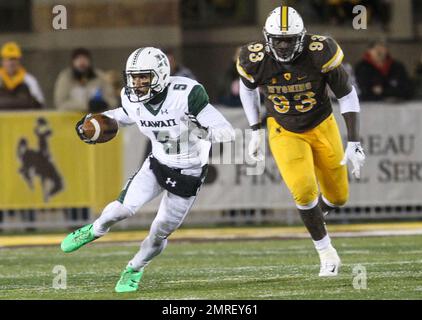 Hawaii wide receiver John Ursua (5) reaches toward the end zone as Wyoming  free safety Andrew Winged (28) during their game Saturday, Sept. 23, 2017.  (Josh Galemore/The Casper Star-Tribune via AP Stock